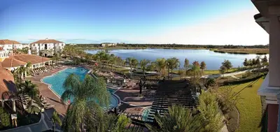 a view of a resort with a pool and a lake at Apartment at Vista Cay Resort in Orlando