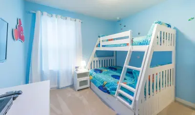 a blue room with a bunk bed with a ladder at Townhome at Compass Bay Community in Kissimmee
