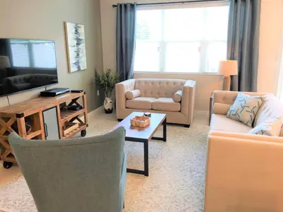 a living room with two couches and a coffee table at Townhome at Compass Bay Community in Kissimmee