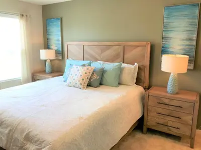 a bedroom with a bed with pillows and two lamps at Townhome at Compass Bay Community in Kissimmee
