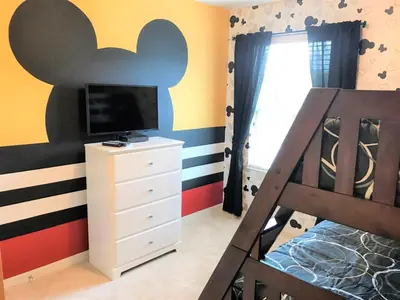 a bedroom with a bed and a tv at Townhome at Compass Bay Community in Kissimmee