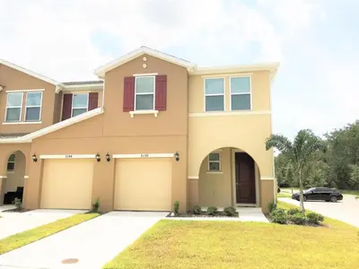 a large house with a garage at Townhome at Compass Bay Community in Kissimmee