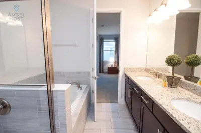 a bathroom with two sinks and a shower at Private Pool and Spa Home at Encore Resort at Reunion in Orlando