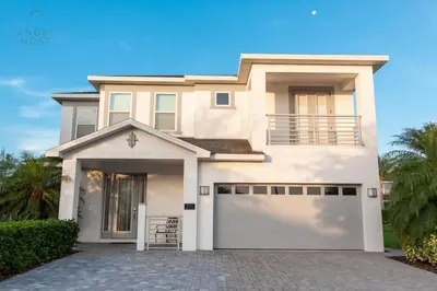 a large white house with a garage at Private Pool and Spa Home at Encore Resort at Reunion in Orlando