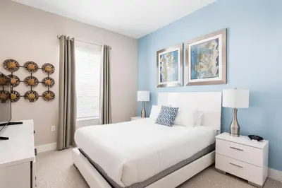 a bedroom with a white bed and a window at GORGEOUS 5 Suites Villa at Summerville Resort in Orlando