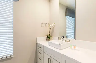 a bathroom with a white sink and a mirror at Fantastic 4 beds Villa 5 min to Disney in Orlando