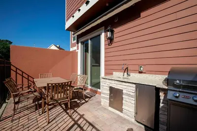 a patio with a table and chairs and a grill at Fantastic 4 beds Villa 5 min to Disney in Orlando