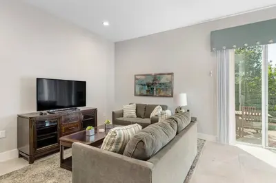 a living room with a couch and a flat screen tv at Fantastic 4 beds Villa 5 min to Disney in Orlando