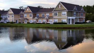 a large building next to a body of water at Orlando House in Kissimmee