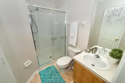 a bathroom with a shower and a toilet and a sink at Private Pool Home at Windsor Palms Resort in Kissimmee