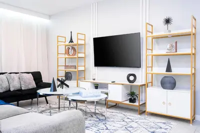 a living room with a couch and a tv at Amazing 3BedroomsNear to DisneyThemed rooms in Kissimmee