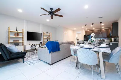 a living room with a couch and a table at Amazing 3BedroomsNear to DisneyThemed rooms in Kissimmee