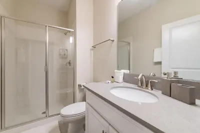a bathroom with a toilet and a sink and a shower at Beautiful house great location private pool in Kissimmee