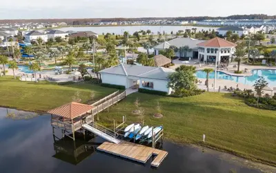 an aerial view of a house on the water with a dock at Beautiful house great location private pool in Kissimmee