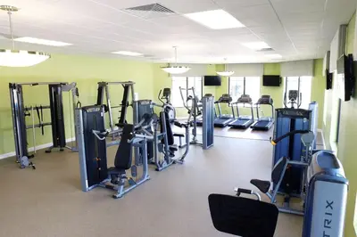 a gym with rows of tread machines in a room at Beautiful house great location private pool in Kissimmee