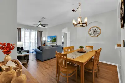 a dining room and living room with a table and chairs at Sunny Condo Retreat at Windsor Hills in Orlando