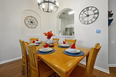 a dining room with a table with santa hats on it at Sunny Condo Retreat at Windsor Hills in Orlando