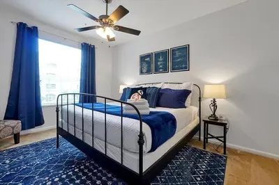 a small child sitting on a bed in a bedroom at Best Family Friendly Spot at Windsor Hills in Orlando