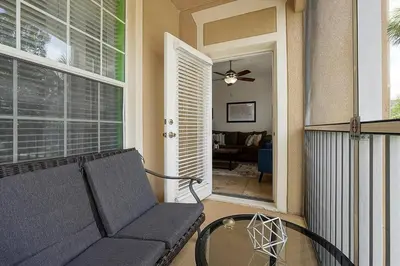 a living room with a couch and a glass table at Best Family Friendly Spot at Windsor Hills in Orlando