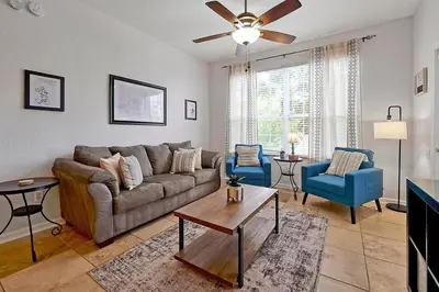 a living room with a couch and a table at Best Family Friendly Spot at Windsor Hills in Orlando
