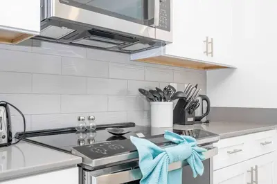 a kitchen with a sink and a stove top oven at NEW to Market 5 Bed - Storey Lake Retreat in Kissimmee