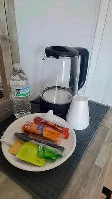 a plate of vegetables on a counter with a blender at Pily's Vintage Stay Room Full Bed in Orlando