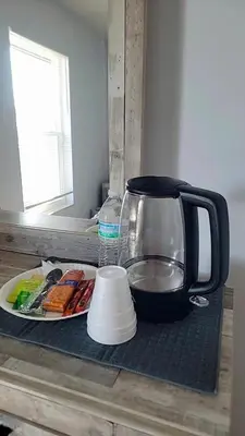 a counter with a tea kettle and a plate of food at Pily's Vintage Stay Room Full Bed in Orlando