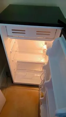 an empty refrigerator with its door open in a room at Pily's Vintage Stay Room Full Bed in Orlando