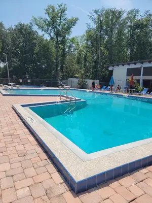a large swimming pool with blue water at Pily's Vintage Stay Room Full Bed in Orlando