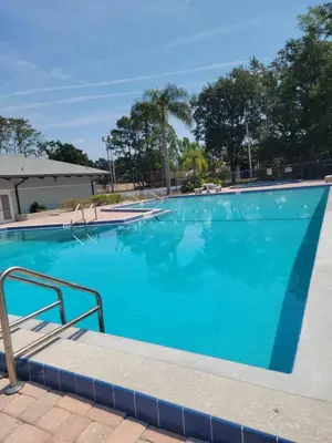 a swimming pool at a resort with blue water at Pily's Vintage Stay Room Full Bed in Orlando