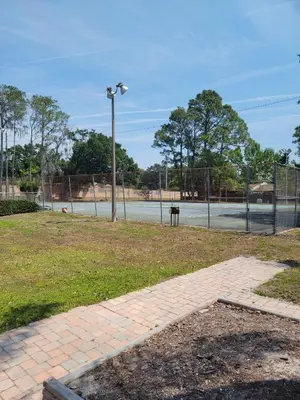 an empty basketball court with a fence and a tennis court at Pily's Vintage Stay Room Full Bed in Orlando