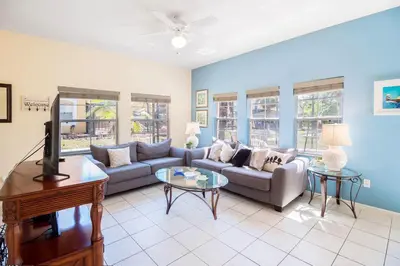 a living room with a couch and a tv at Private Pool Townhome at Encantada Resort in Kissimmee