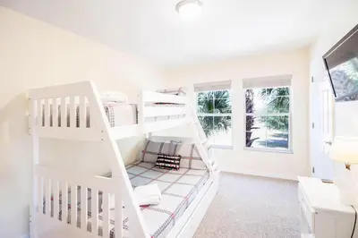 a white bunk bed in a white room with windows at Private Pool Townhome at Encantada Resort in Kissimmee