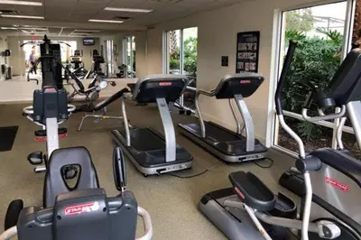 a gym with several cardio bikes and tread machines at Private Pool Townhome at Encantada Resort in Kissimmee