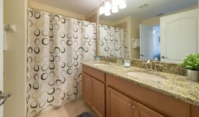 a bathroom with a sink and a large mirror at Private Pool Townhome at Paradise Palms Resort in Kissimmee