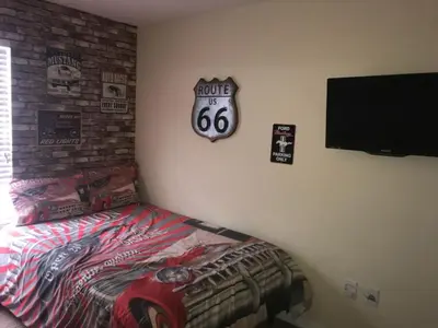 a bedroom with a bed and a sign on the wall at Private Pool Townhome at Paradise Palms Resort in Kissimmee