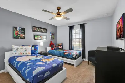 a bedroom with two beds and a ceiling fan at 3069 Beach Palm in Kissimmee