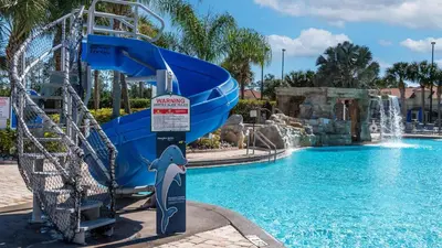 a dolphin water slide in a pool at a resort at 3069 Beach Palm in Kissimmee
