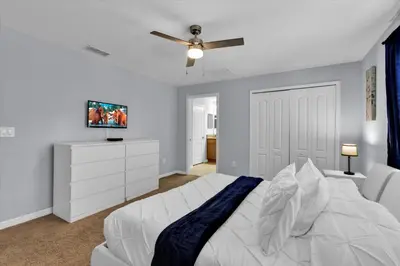 a bedroom with a white bed and a ceiling fan at 3069 Beach Palm in Kissimmee