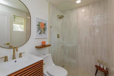 a bathroom with a shower and a toilet and a sink at Hope Home in Clermont