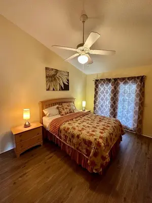 a bedroom with a bed and a ceiling fan at Grand Holiday 3BR Condo Resort near Disney Parks in Kissimmee