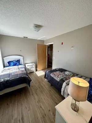 a bedroom with two beds and a table with a lamp at Grand Holiday 3BR Condo Resort near Disney Parks in Kissimmee