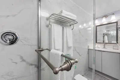 a bathroom with a shower with a glass door at Exclusive Second-Floor Apartment in Orlando