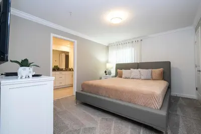 a bedroom with a bed and a living room at Free Waterpark 5Bd Close to Disney Private Pool 2497 in Kissimmee
