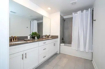 a white bathroom with a sink and a shower at Free Waterpark 5Bd Close to Disney Private Pool 2497 in Kissimmee