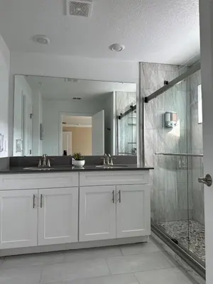 a bathroom with two sinks and a large mirror at COLORING in Kissimmee