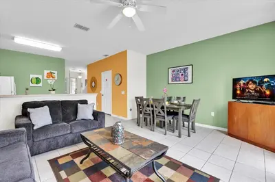 a living room with a couch and a table at 7644 Sir Kaufmann in Kissimmee