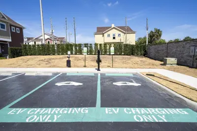 a parking lot with a car charging ev charging only at Magical Themed Home Near Disney in Orlando