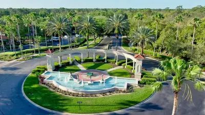 an aerial view of a resort with a swimming pool and palm trees at 2764 Sun Key in Kissimmee