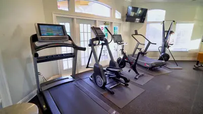 a gym with exercise bikes and a laptop on a treadmill at 2764 Sun Key in Kissimmee